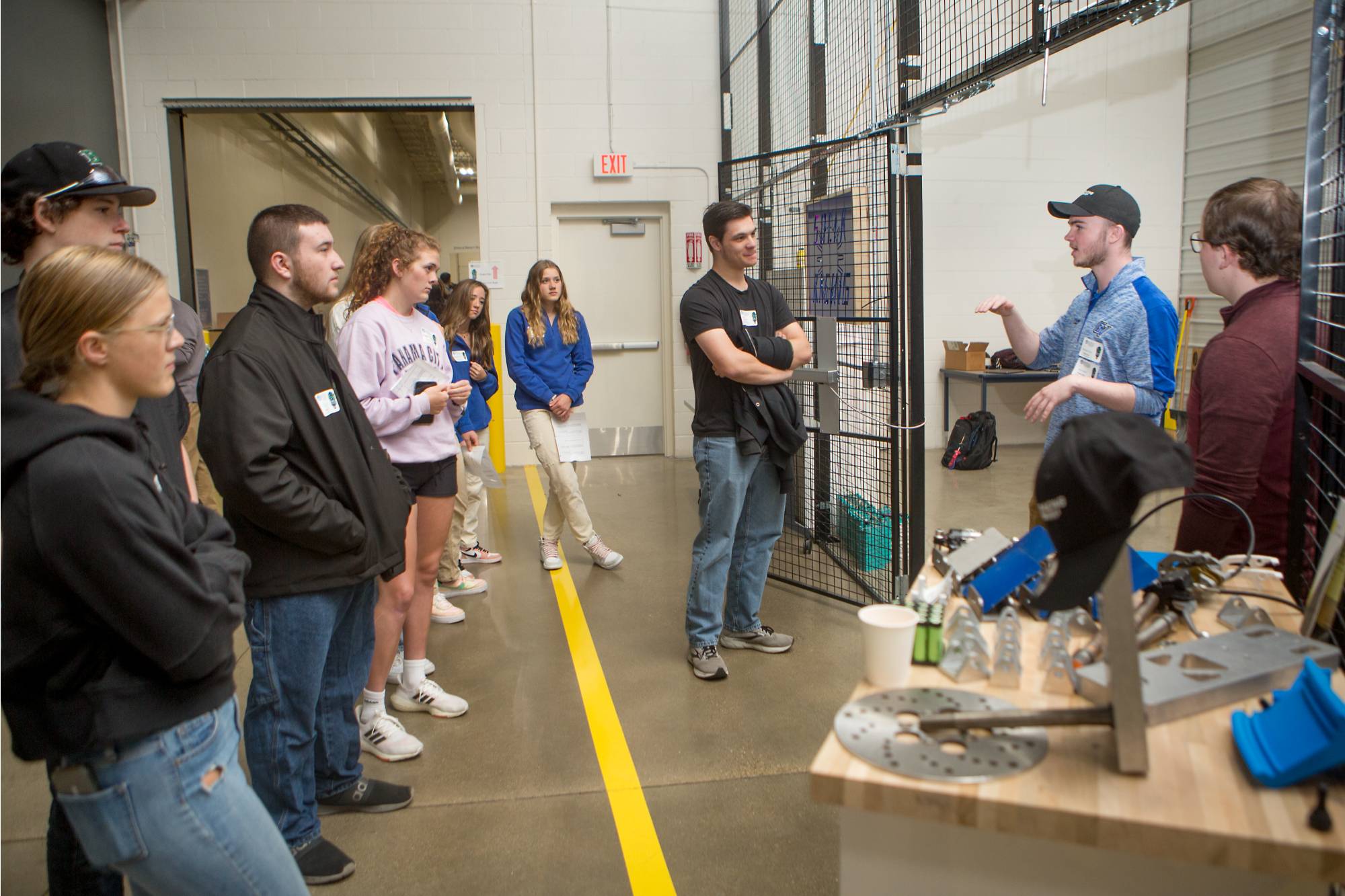 Students interacting at Project Day near Laker Racing solar car